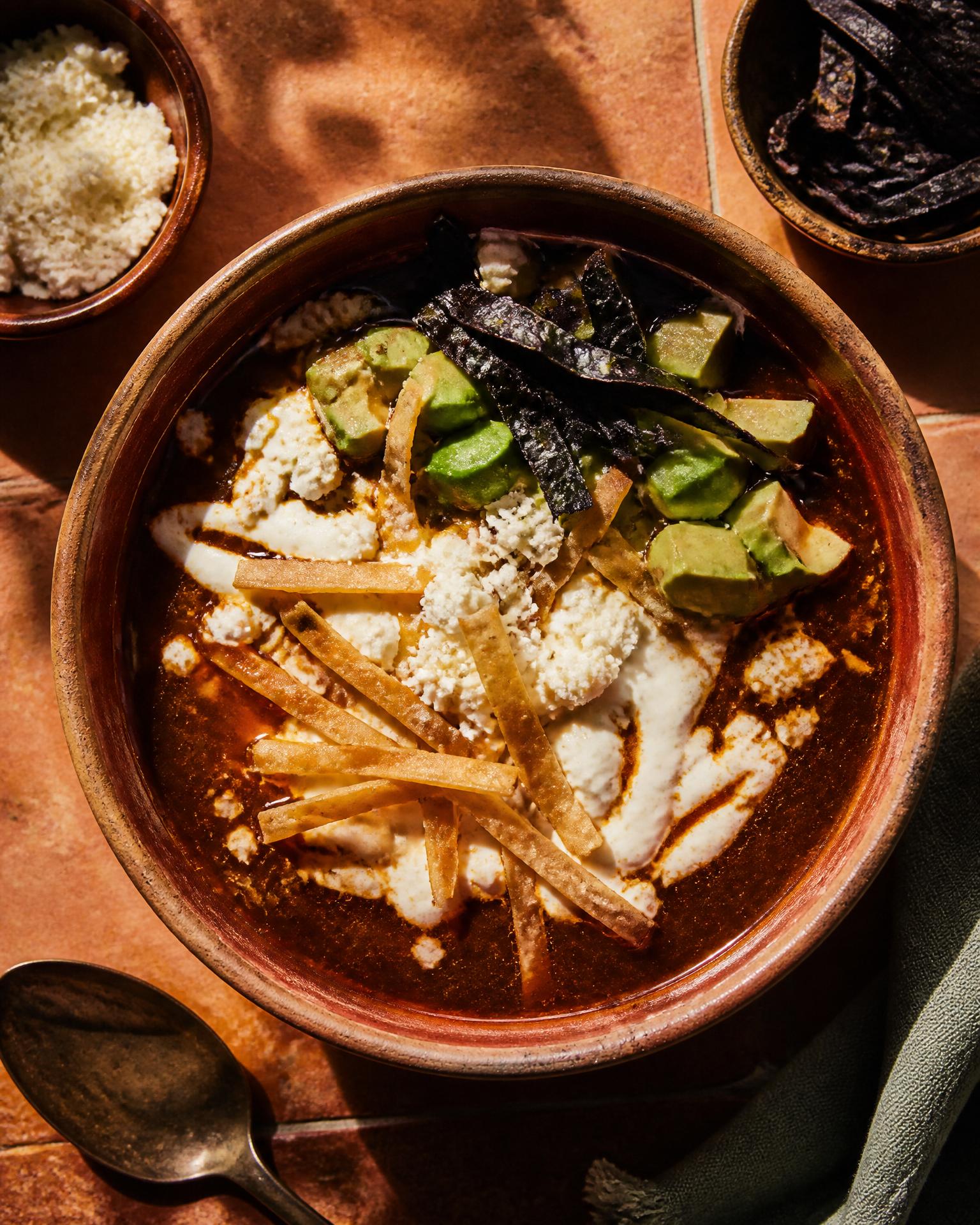 Sopa de tortilla with tortilla strips and avocado